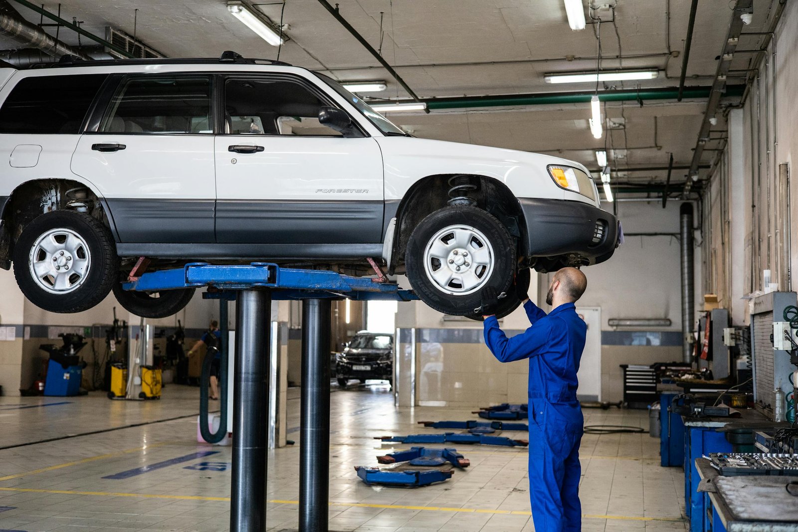 A Mechanic Inspecting a Vehicle